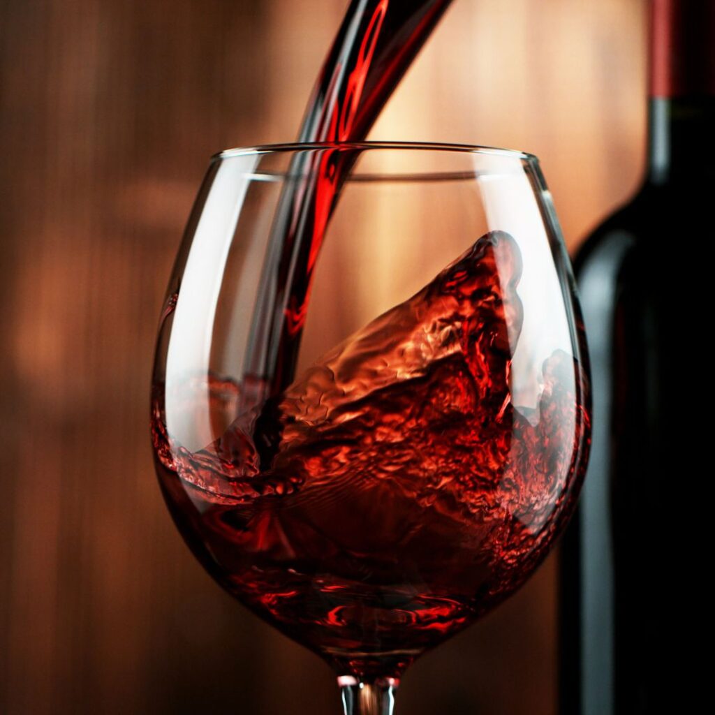 red wine being poured into wine glass